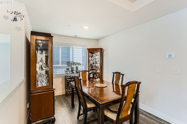 dining area with dark wood finished floors and baseboards