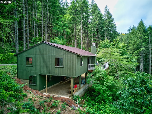 272 Whipple Tree Dr, Yoncalla, OR 97499 - view of side of home featuring a forest view, a chimney, and a patio area