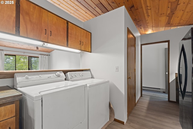 272 Whipple Tree Dr, Yoncalla, OR 97499 - washroom featuring a baseboard heating unit, separate washer and dryer, cabinet space, wood ceiling, and light wood-style floors