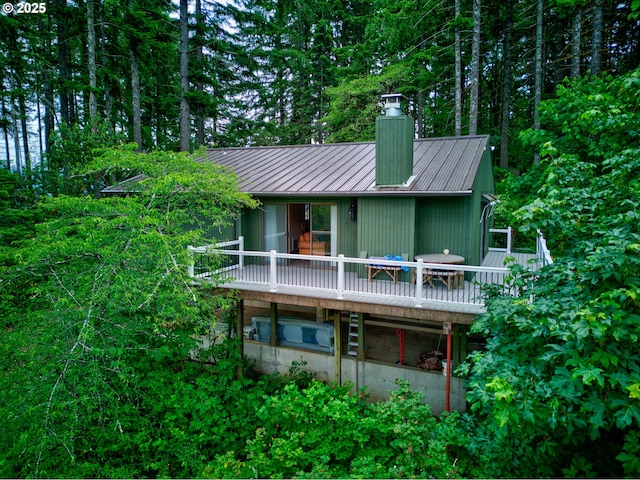272 Whipple Tree Dr, Yoncalla, OR 97499 - rear view of house featuring a chimney, metal roof, a standing seam roof, and a deck