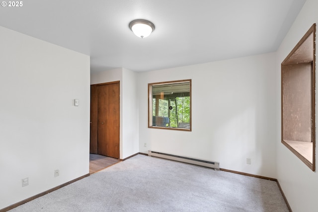272 Whipple Tree Dr, Yoncalla, OR 97499 - spare room featuring a baseboard heating unit, carpet flooring, and baseboards