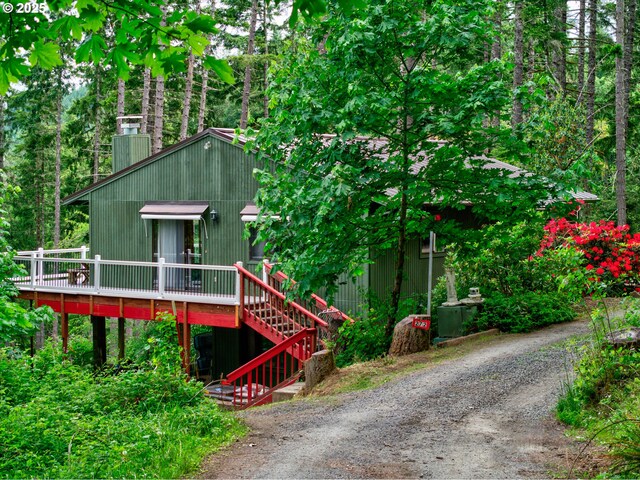 272 Whipple Tree Dr, Yoncalla, OR 97499 - chalet / cabin with a wooden deck, a chimney, driveway, and stairs