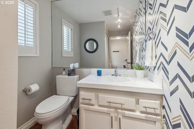 4880 SW Scholls Ferry Rd Unit 14, Portland, OR 97225 - bathroom featuring vanity, toilet, baseboards, wood finished floors, and visible vents