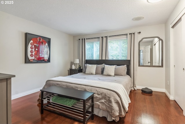 4880 SW Scholls Ferry Rd Unit 14, Portland, OR 97225 - bedroom with baseboards, a textured ceiling, and wood finished floors