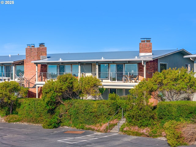 exterior space featuring brick siding and a chimney