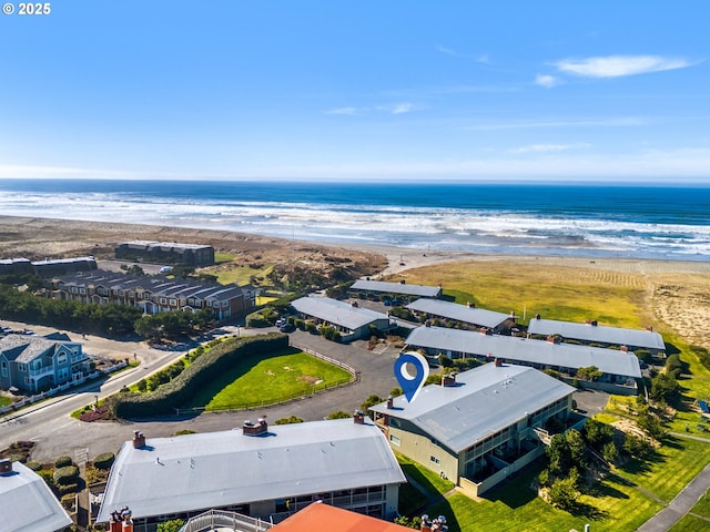 birds eye view of property with a view of the beach and a water view