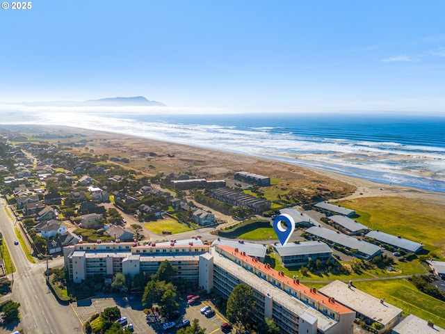 bird's eye view with a water view and a view of the beach