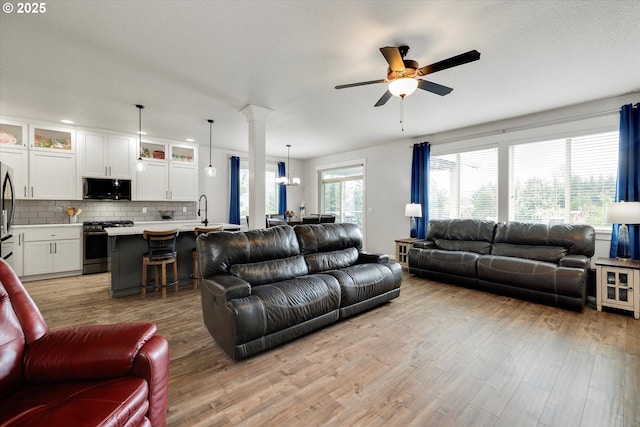 12241 Mimosa Way, Oregon City, OR 97045 - living area with ceiling fan, light wood finished floors, and a chandelier