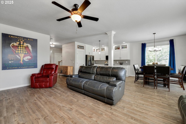 12241 Mimosa Way, Oregon City, OR 97045 - living area featuring a ceiling fan, a chandelier, light wood finished floors, and a textured ceiling