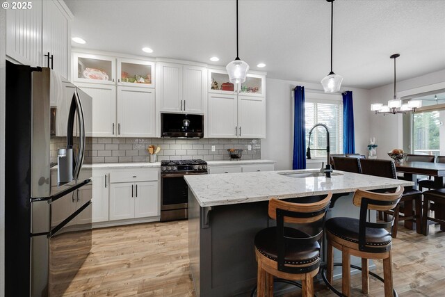 12241 Mimosa Way, Oregon City, OR 97045 - kitchen with appliances with stainless steel finishes, plenty of natural light, light wood-style flooring, white cabinets, and recessed lighting