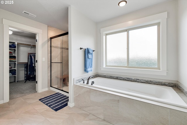 12241 Mimosa Way, Oregon City, OR 97045 - bathroom featuring a shower stall, a spacious closet, and a garden tub