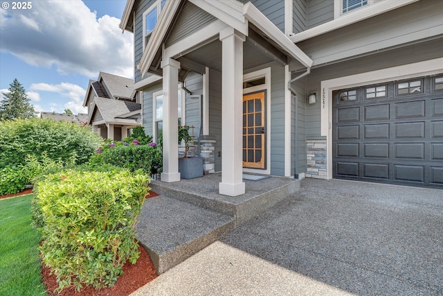 12241 Mimosa Way, Oregon City, OR 97045 - doorway to property featuring a garage and stone siding