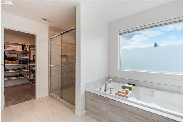 2341 Turnbull Ct, Forest Grove, OR 97116 - bathroom featuring a walk in closet, a bath, a shower stall, and tile patterned flooring