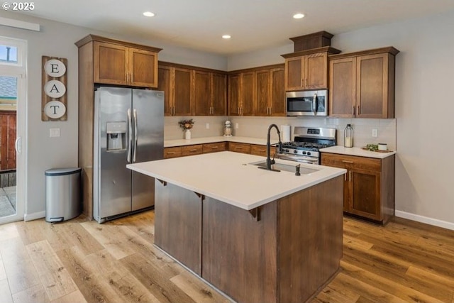 2341 Turnbull Ct, Forest Grove, OR 97116 - kitchen featuring appliances with stainless steel finishes, light wood-style flooring, light countertops, and recessed lighting