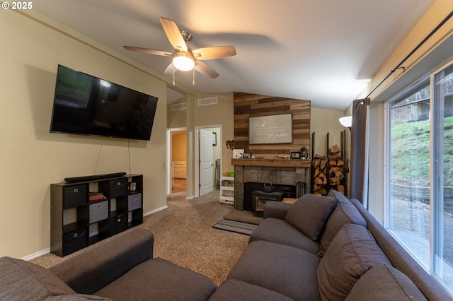 living room featuring ceiling fan, vaulted ceiling, carpet floors, and a fireplace