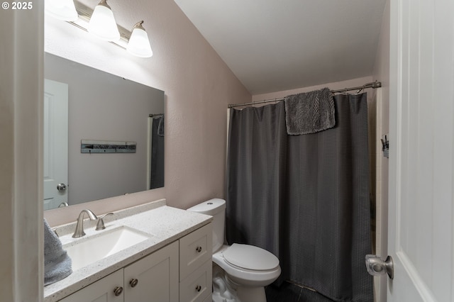 bathroom featuring lofted ceiling, toilet, a shower with curtain, and vanity