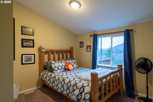 carpeted bedroom with vaulted ceiling