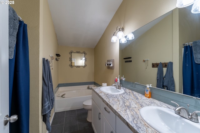 bathroom with vanity, tile patterned flooring, toilet, and a tub