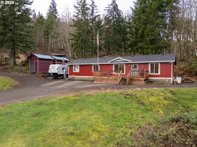 view of front of home featuring a front yard and a deck