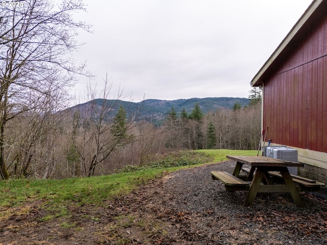 view of yard featuring central air condition unit and a mountain view