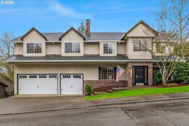 view of front facade with aphalt driveway, brick siding, a chimney, and an attached garage