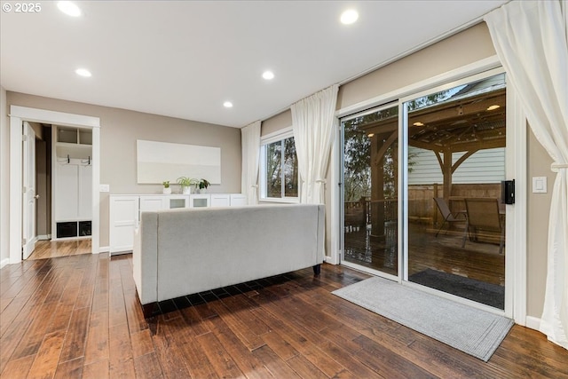 living area with dark wood-type flooring, recessed lighting, and baseboards