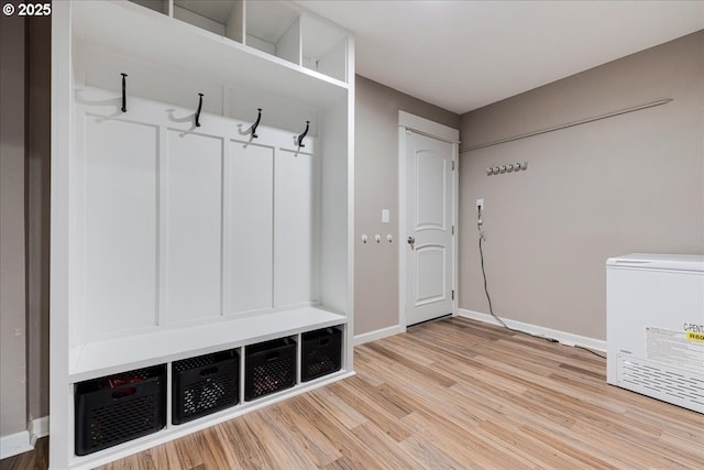 mudroom featuring baseboards and wood finished floors