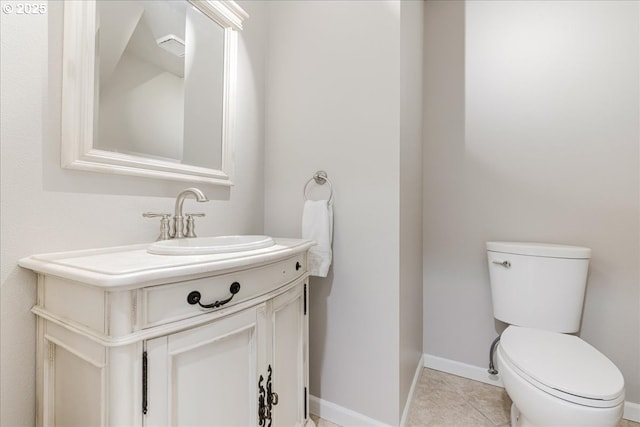 bathroom featuring tile patterned floors, toilet, vanity, and baseboards