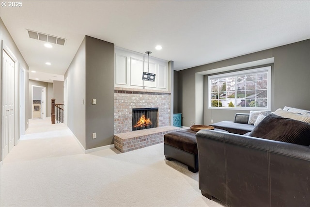 living area featuring visible vents, a brick fireplace, baseboards, light carpet, and recessed lighting