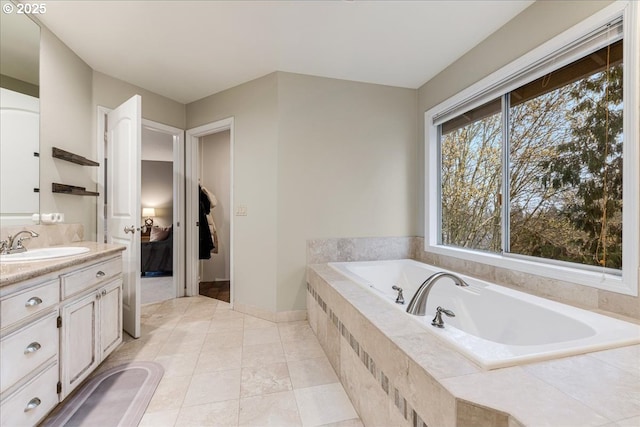 bathroom featuring vanity, a garden tub, and tile patterned floors