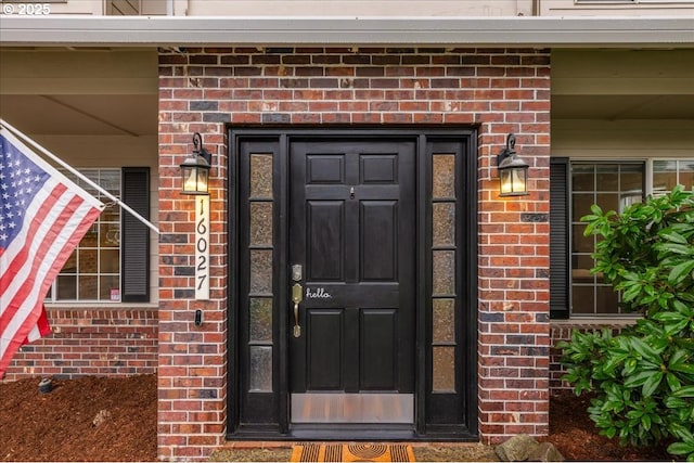 entrance to property with brick siding