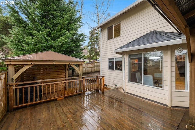 wooden terrace with a gazebo and fence