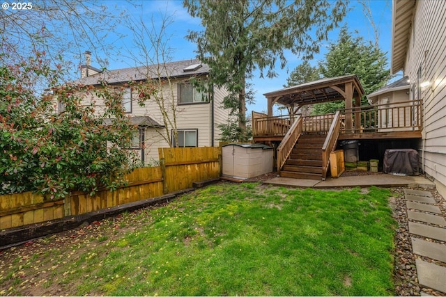 view of yard with a wooden deck, stairway, and fence private yard