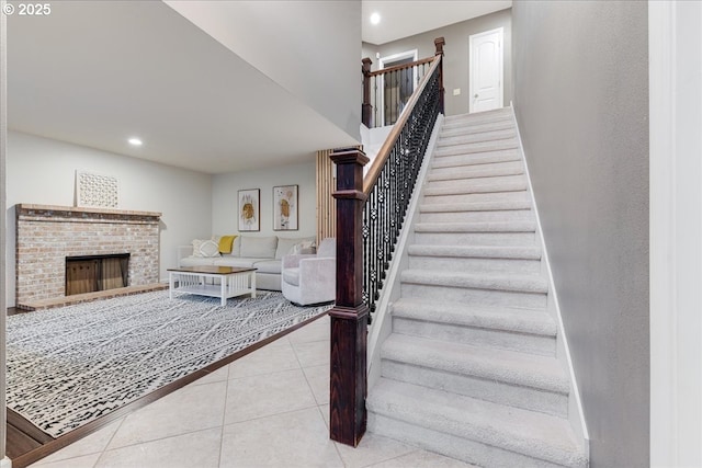 staircase with tile patterned flooring, recessed lighting, a fireplace, and baseboards