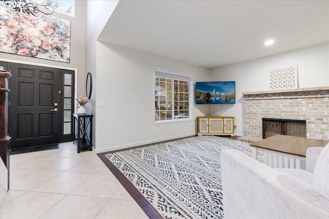 entrance foyer featuring light tile patterned flooring, recessed lighting, a fireplace, and baseboards