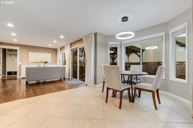 tiled dining area featuring recessed lighting and baseboards