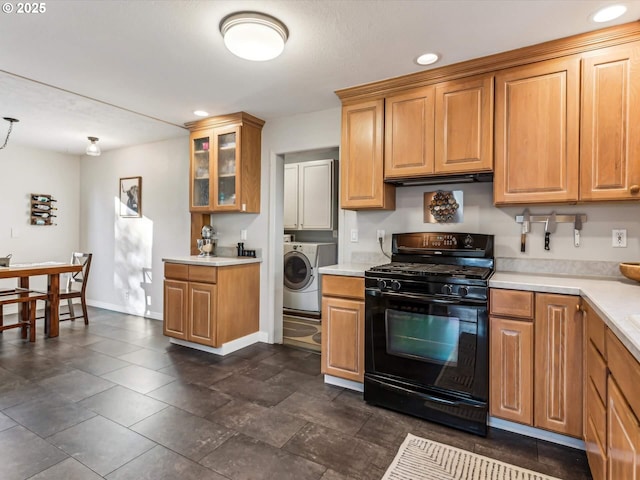 kitchen featuring black gas stove and washer / dryer