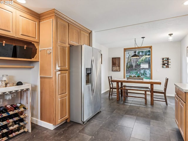 kitchen with stainless steel fridge with ice dispenser, decorative light fixtures, and beverage cooler