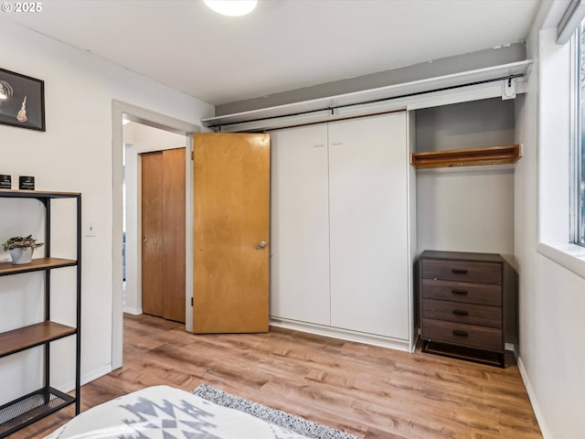 bedroom with a closet and light hardwood / wood-style flooring