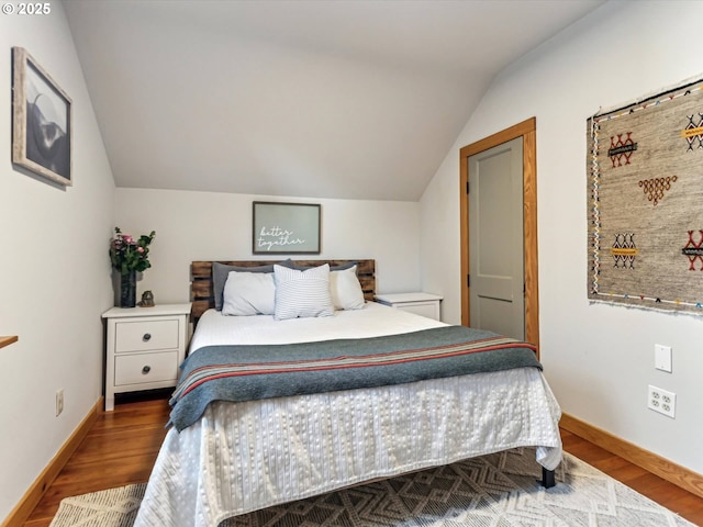 bedroom with lofted ceiling and hardwood / wood-style floors