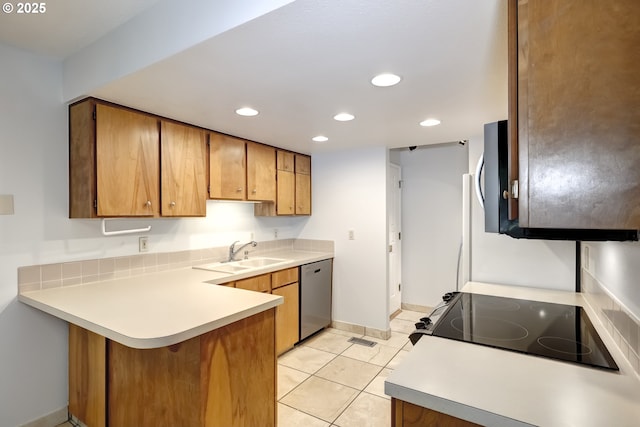 15000 SW Farmington Rd Unit 51, Beaverton, OR 97007 - kitchen featuring appliances with stainless steel finishes, a sink, a peninsula, brown cabinetry, and recessed lighting