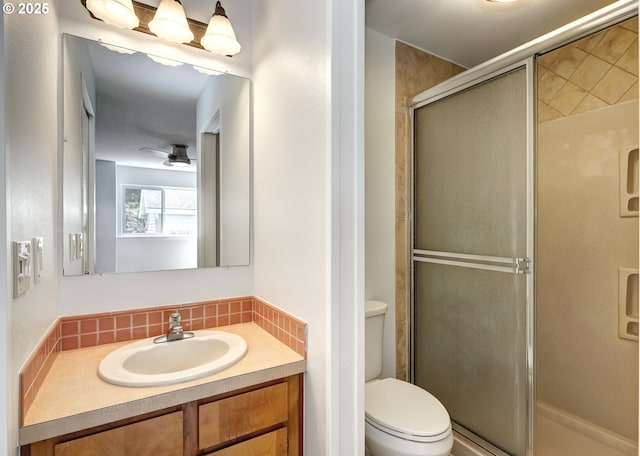 15000 SW Farmington Rd Unit 51, Beaverton, OR 97007 - bathroom featuring a stall shower, vanity, toilet, a ceiling fan, and backsplash