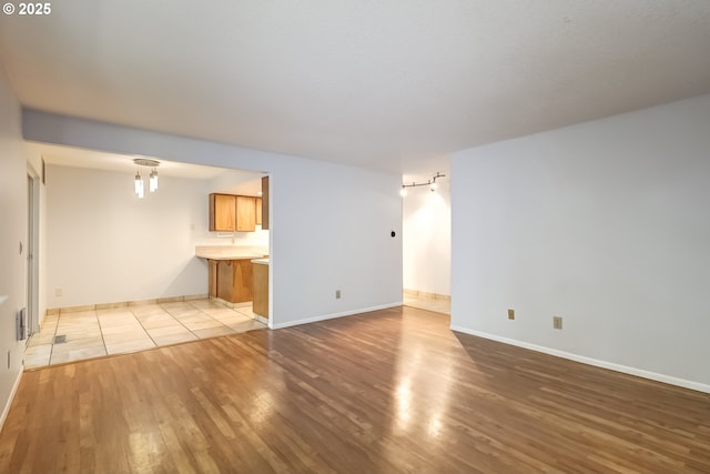 15000 SW Farmington Rd Unit 51, Beaverton, OR 97007 - unfurnished living room featuring wood finished floors and baseboards