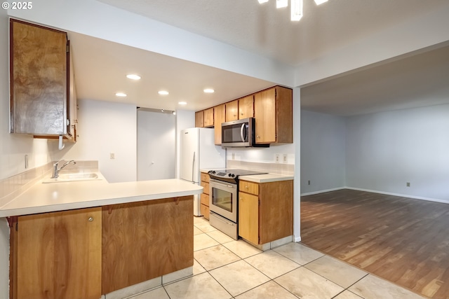15000 SW Farmington Rd Unit 51, Beaverton, OR 97007 - kitchen with stainless steel appliances, a sink, light countertops, recessed lighting, and a peninsula