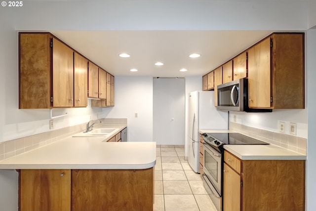 15000 SW Farmington Rd Unit 51, Beaverton, OR 97007 - kitchen featuring appliances with stainless steel finishes, a sink, light countertops, recessed lighting, and light tile patterned floors