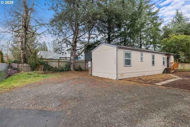 view of home's exterior featuring fence