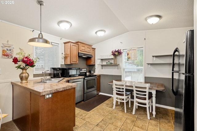 kitchen featuring pendant lighting, lofted ceiling, a sink, under cabinet range hood, and black appliances