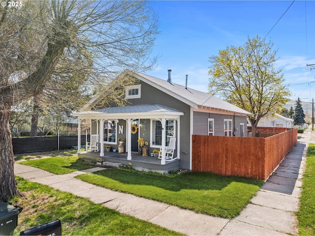 exterior space featuring a yard, fence, and covered porch