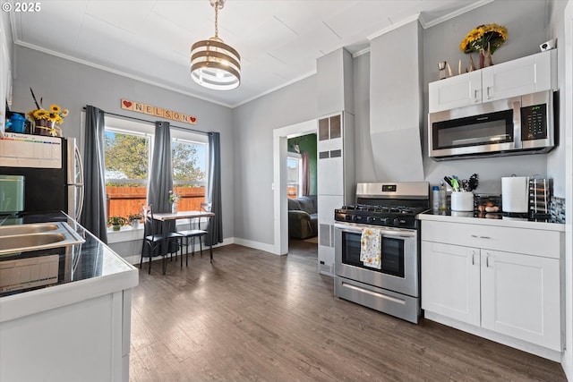kitchen featuring crown molding, white cabinetry, and stainless steel appliances