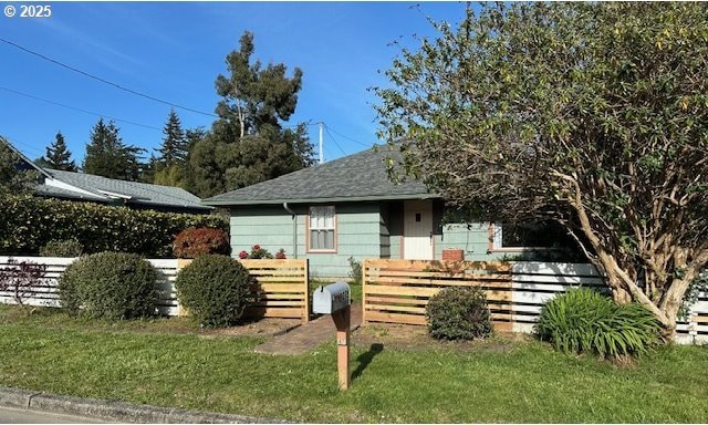 view of front of property with fence and a shingled roof